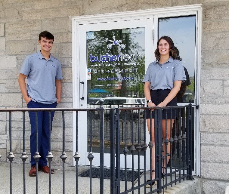 Buchertech interns Grace Good and Elliot Bland at the office entrance